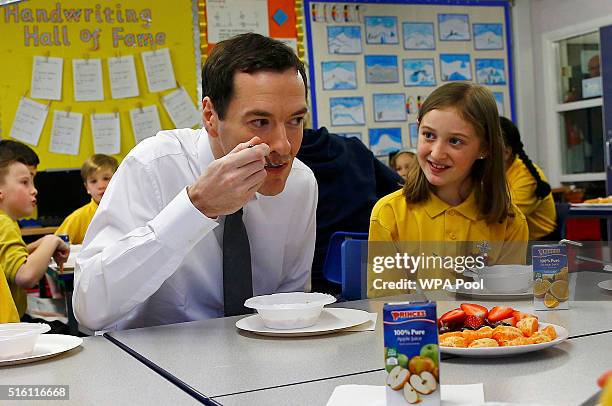 Chancellor of the Exchequer George Osborne eats with pupils during breakfast club at St Benedict's Catholic Primary School on March 17, 2016 in...