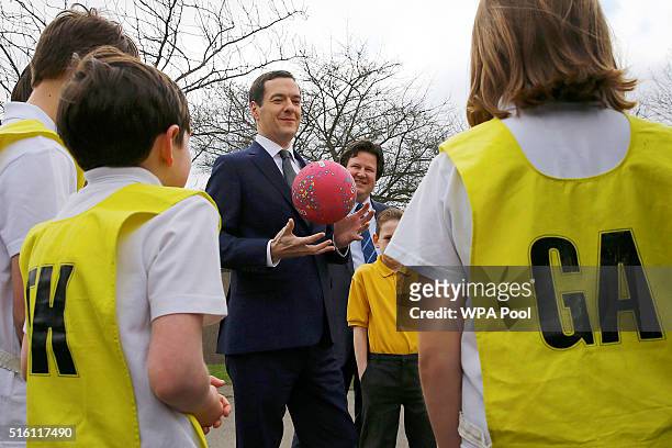 Chancellor of the Exchequer George Osborne speaks to pupils during a netball lesson at St Benedict's Catholic Primary School on March 17, 2016 in...