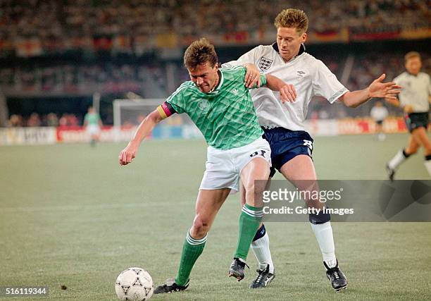 England winger Chris Waddle challenges West Germany captain Lothar Matthäus during the 1990 FIFA World Cup Semi Final at Stadio delle Alpi on July...