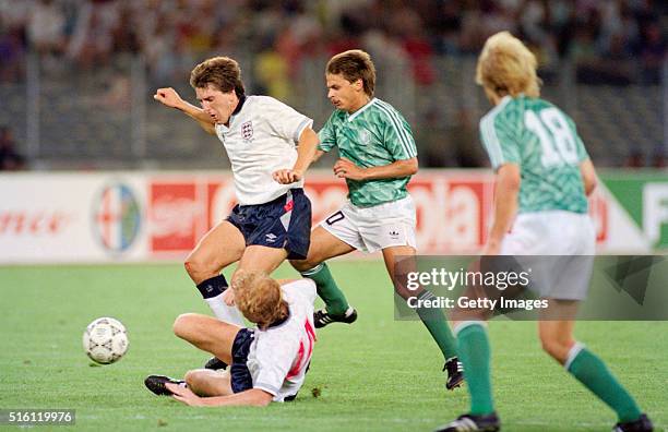 England players Mark Wright and Peter Beardsley combine to thwart Olaf Thon of West Germany during the 1990 FIFA World Cup Semi Final at Stadio delle...