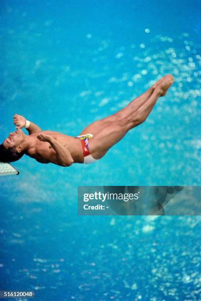 Two-time Los Angeles gold medalist Greg Louganis of the U.S. Bangs his head against the board after mistiming his dive during the Olympic...