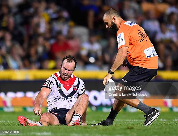 Ian Henderson of the Roosters points to his lower leg after being injured during the round three NRL match between the North Queensland Cowboys and...