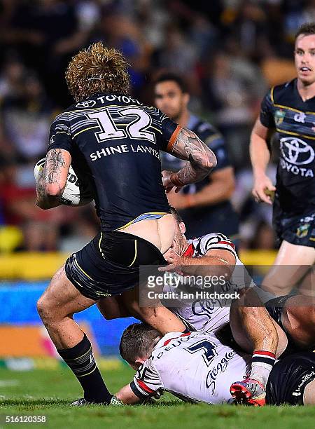 Ian Henderson of the Roosters has his lower leg broken whilst trying to tackle Ethan Lowe of the Cowboys during the round three NRL match between the...