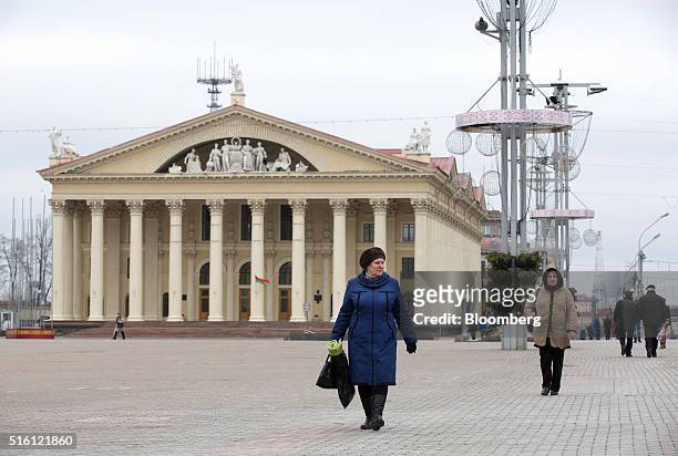 Pedestrians walk across a city square past the Minsk Trade Union Palace of Culture in Minsk, Belarus, on Wednesday, March 16, 2016. European Union...
