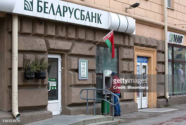 Customer uses an automated teller machine outside a Belarusbank bank branch in Minsk, Belarus, on Wednesday, March 16, 2016. European Union...