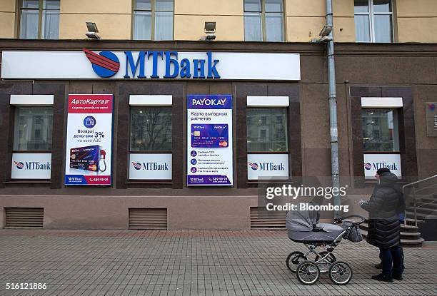 Pedestrians pause outside a branch of the Minsk Transit Bank CJSC, also known as MTBank, in Minsk, Belarus, on Wednesday, March 16, 2016. European...