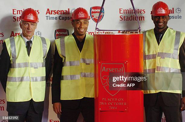 Arsenal manager Arsene Wenger and players Thierry Henry and Patrick Vieira place a specially-made time capsule containing memories and keepsakes from...