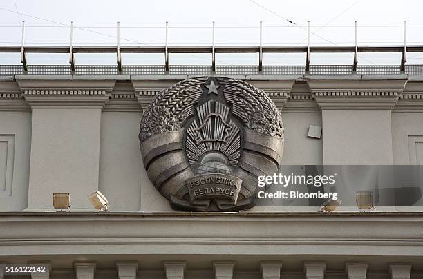 The coat of arms of the Belarus Republic sits on display outside the headquarters of the National Bank of Belarus on Independence avenue in Minsk,...