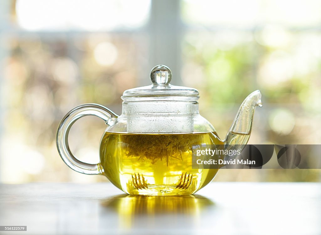 Chamomile tea in a clear teapot