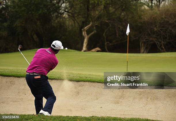 Shiv Kapur of India plays a bunker shot during the first round of Hero Indian Open at Delhi Golf Club on March 17, 2016 in New Delhi, India.