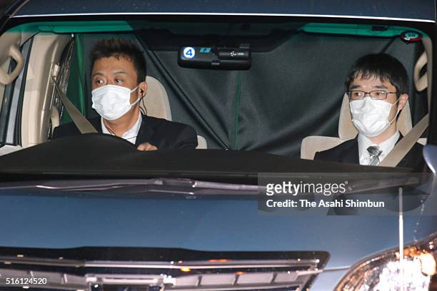 Car carrying former baseball star Kazuhiro Kiyohara runs past media reporters at the Tokyo Metropolitan Police Department headquarters after being...
