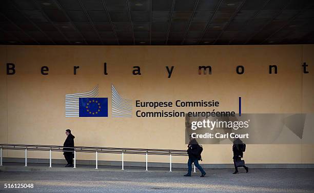 People walk under signage at the European Commission headquarters building ahead of the EU-Turkey Summit which starts today on March 17, 2016 in...