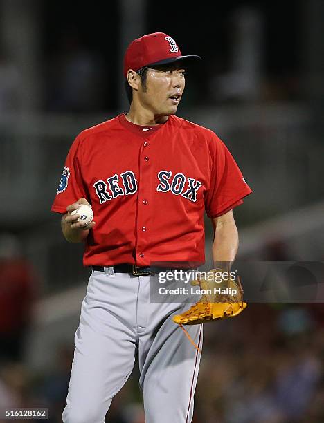 Koji Uehara of the Boston Red Sox reacts after giving up a solo home run to Eddie Rosario of the Minnesota Twins during the fifth inning of the...