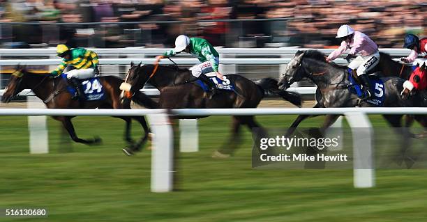 Niall P Madden on Rathpatrick , eventual winner Davy Russell on Mall Dini and Sean Bowen on Arpege D'Alene race to the finish line in the Pertemps...