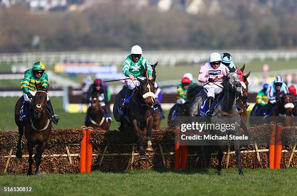 Niall P Madden on Rathpatrick , eventual winner Davy Russell on Mall Dini and Sean Bowen on Arpege D'Alene jump a hurdle in the Pertemps Network...