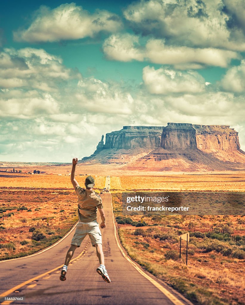 Happiness man jumping on the road