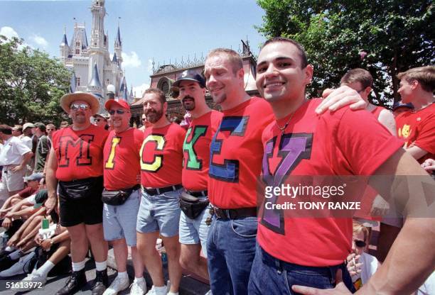 Six gays spell out the word "Mickey" on their shirts at the base of the Walt Disney World Castle during Gay Days 05 June 1999 in Lake Buena Vista,...