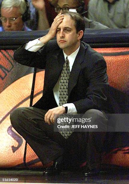 New York Knicks Head Coach Jeff Van Gundy holds his head while he watches his team play the Indiana Pacers 09 June during the first half of game five...