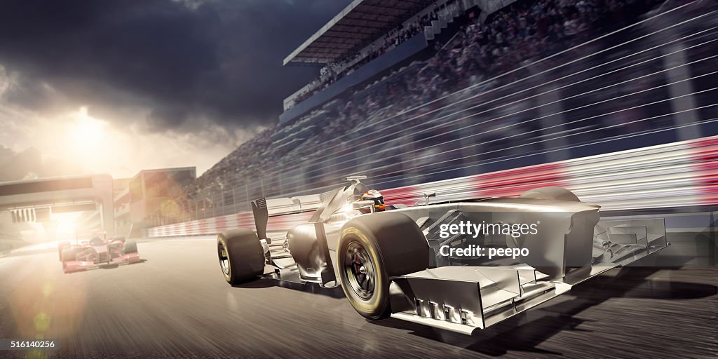 Racing Car During Race on Track At Sunset