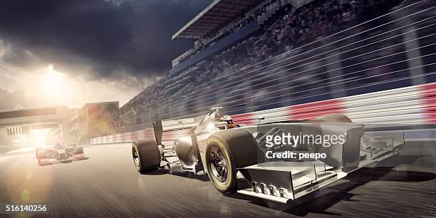 racing car during race on track at sunset - car racing stock pictures, royalty-free photos & images