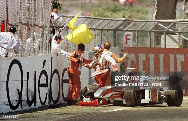 Canadian F-1 driver Jacques Villeneuve jumps out of his car after crashing at the Circuit Gilles Villeneuve during the Canadian Grand Prix in...