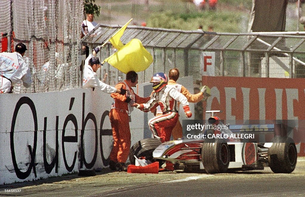 Canadian F-1 driver Jacques Villeneuve jumps out o