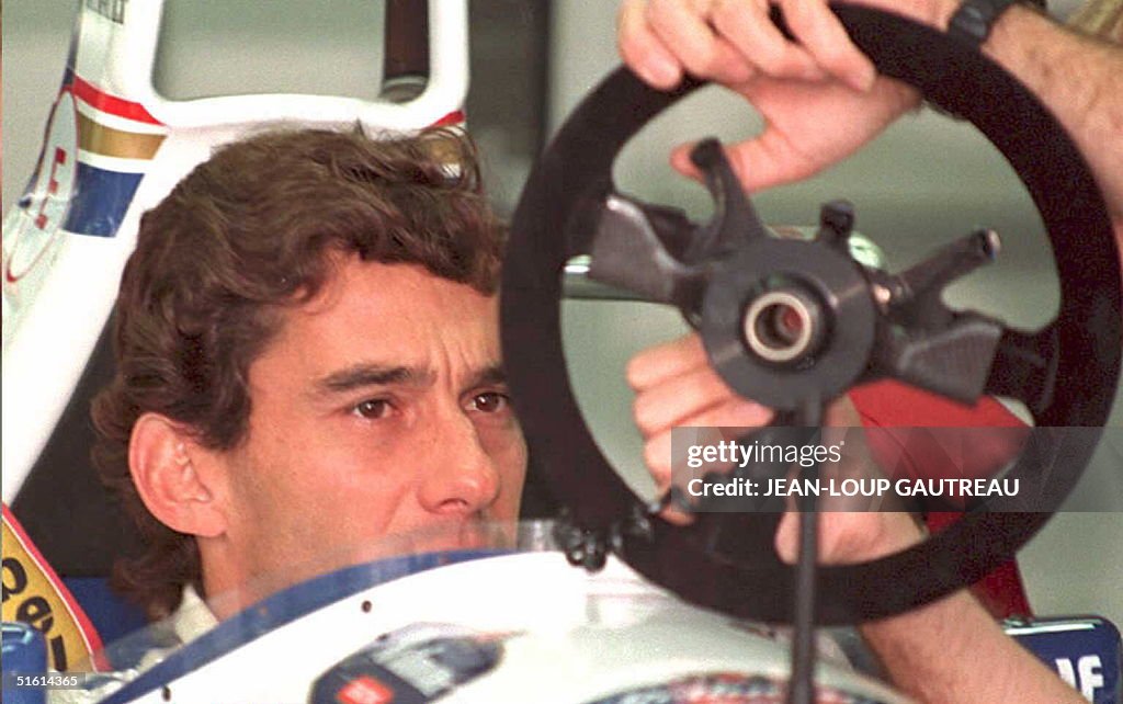 Brazilian Formula One driver Ayrton Senna inspects