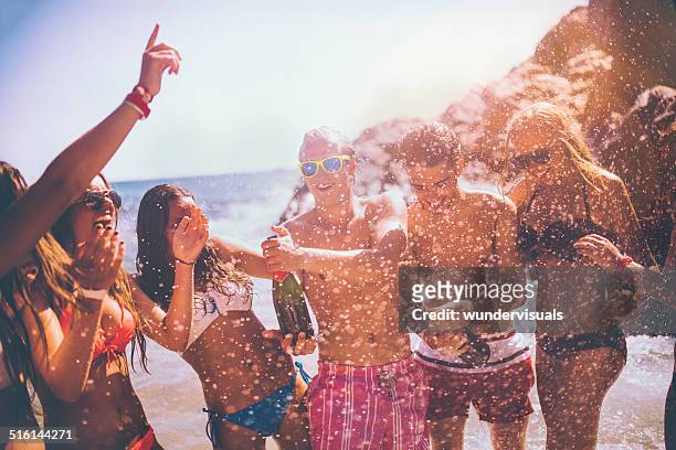friends popping champagne - spraying champagne stock pictures, royalty-free photos & images