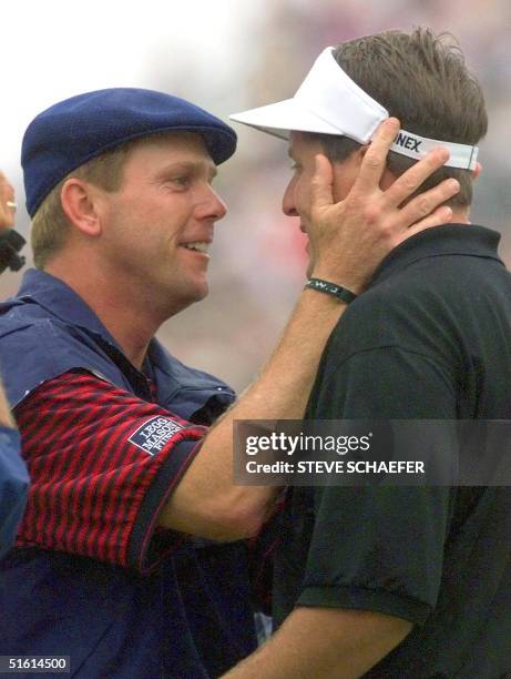 Payne Stewart of the US embraces Phil Mickelson of the US, after Stewart sank his putt on the eighteenth green at Pinehurst No. 2 during the final...