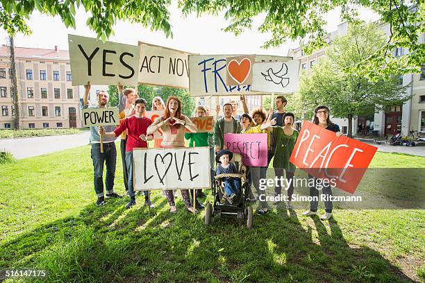 group of young people demonstrating with banners - person holding up sign stock-fotos und bilder