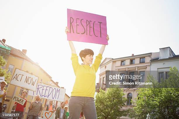 young female activist demonstrating with banner - march 22 2013 stock pictures, royalty-free photos & images