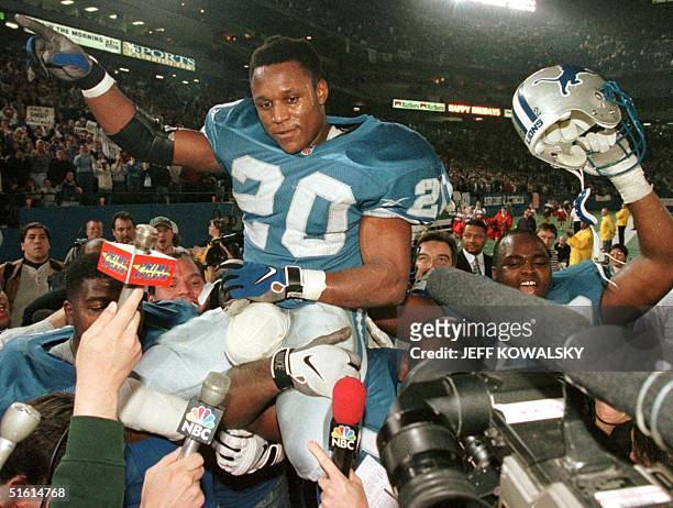 This 21 December 1997 file photo show Detroit Lions Barry Sanders as he is carried off of the field by his teammates after he became one of three...