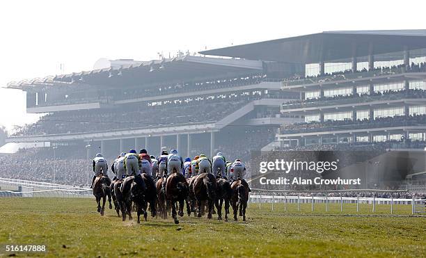 General view as runners turn into the straight in The Pertemps Network Final clear a hurdle in the country during Cheltenham Festival - St Patrick's...