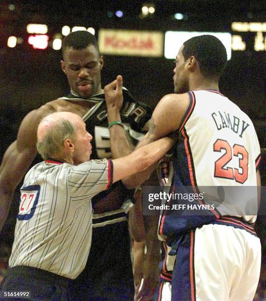 Official Dick Bavetta separates San Antonia Spurs David Robinson and New York Knicks Marcus Camby during game three of the NBA Finals 21 June, 1999...