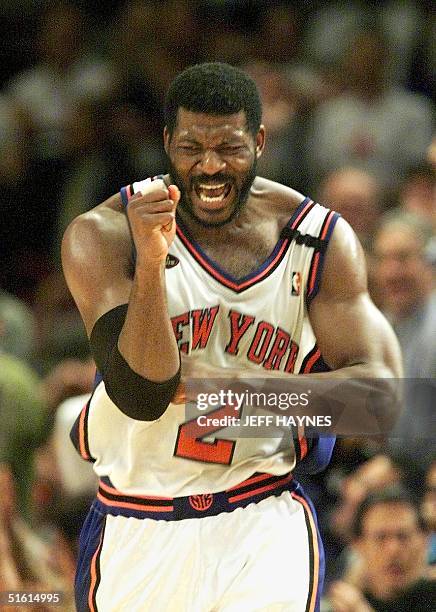 New York Knicks player Larry Johnson celebrates as the Knicks beat the San Antonio Spurs in game three of the NBA Finals 21 June, 1999 at New York's...