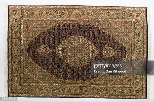Persian 'Tabriz' rug is displayed at the Oriental Rug Centre's main warehouse on March 17, 2016 in London, England. The Oriental Rug Centre in North...