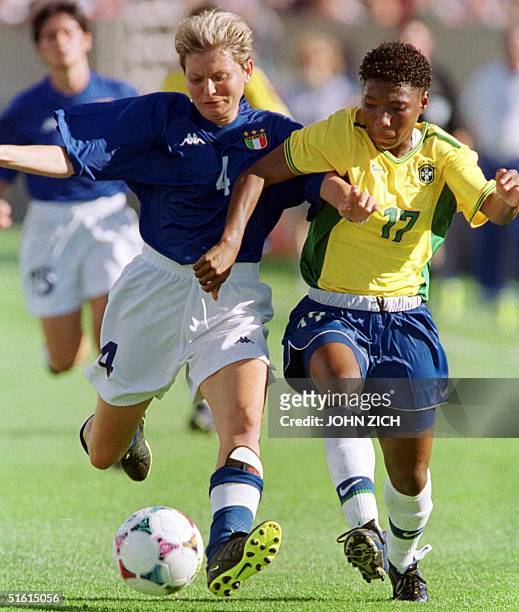 Italy's Luisa Marchio battles for control of the ball with Brazil's Pretinha in the first half of their Women's World Cup game 24 June 1999, at...