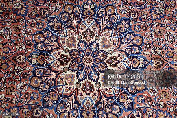 An antique 'Dorokhsh' Persian Rug is displayed in the Oriental Rug Centre's main warehouse on March 17, 2016 in London, England. The Oriental Rug...