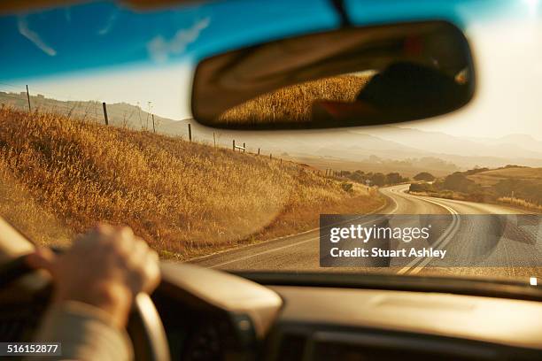 car driving along highway, sunrise - rear view mirror 個照片及圖片檔