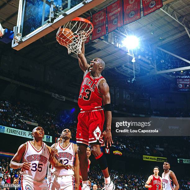 Michael Jordan of the Chicago Bulls dunks against the Philadelphia 76ers on March 18, 1996 at the Spectrum in Philadelphia, Pennsylvania. NOTE TO...