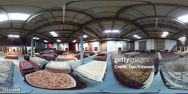 Managing director of the Oriental Rug Centre, Jalil Ahwazian rolls a Persian 'Bidjar' rug in the Oriental Rug Centre's main warehouse on March 17,...