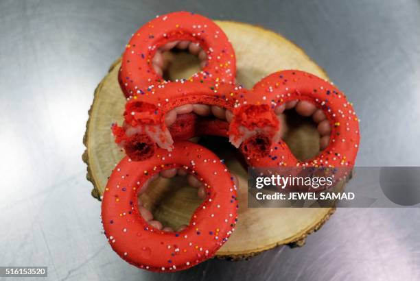 Macaronuts, a fusion between macaron and doughnut, made by French pastry chef François Payard are pictured at his bakery in New York on March 17,...