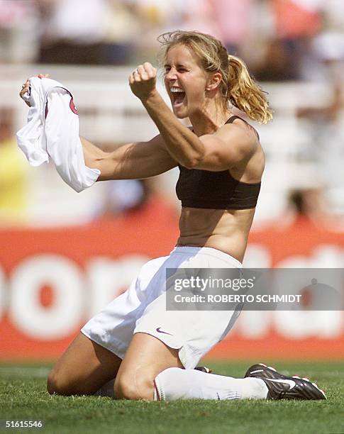 Brandi Chastain of the US celebrates after kicking the winning penalty kick to win the 1999 Women's World Cup final against China 10 July 1999 at the...