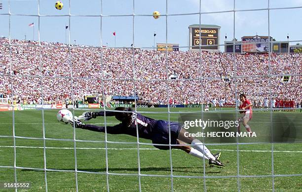 Goalkeeper Briana Scurry lunges as she stops the penalty kick by Liu Ying of the Chinese soccer team in a shoot-out at the end of their game in the...