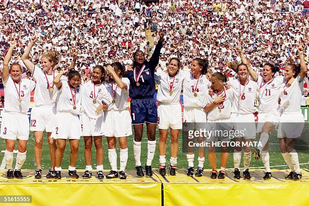 The US women's soccer team show off their gold medals after defeating China in a penalty kick shoot-out to win the 1999 Women's World Cup 10 July...