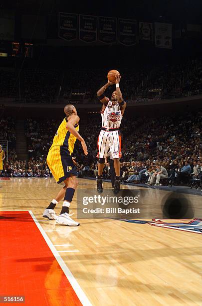 Steve Francis of the Houston Rockets puts up a jump shot over Reggie Miller of the Indiana Pacers at the Compaq Center in Houston, Texas. DIGITAL...