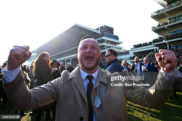 Racegoers celebrate after Thistlecrack wins the Ryanair World Hurdle during St Patrick's Day at the Cheltenham Festival at Cheltenham Racecourse on...