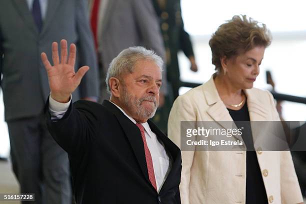 Brazil's former president, Luiz Inacio Lula da Silva walks with President Dilma Rousseff as he is sworn in as the new chief of staff in the Planalto...