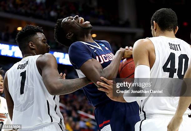 Amida Brimah of the Connecticut Huskies battles for a rebound with Wesley Gordon and Josh Scott of the Colorado Buffaloes in the first half during...