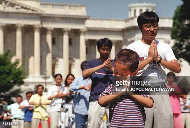 Falungong followers meditate 29 July outside the US Capitol in Washington, DC. The group received assurances from the US State Department that they...